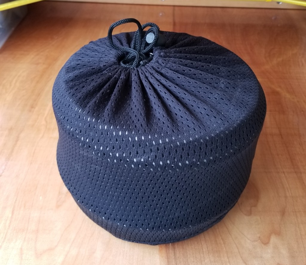 back-country cookware set nestled together in mesh storage bag