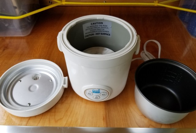 small rice cooker with lid off and inner cooking bowl removed