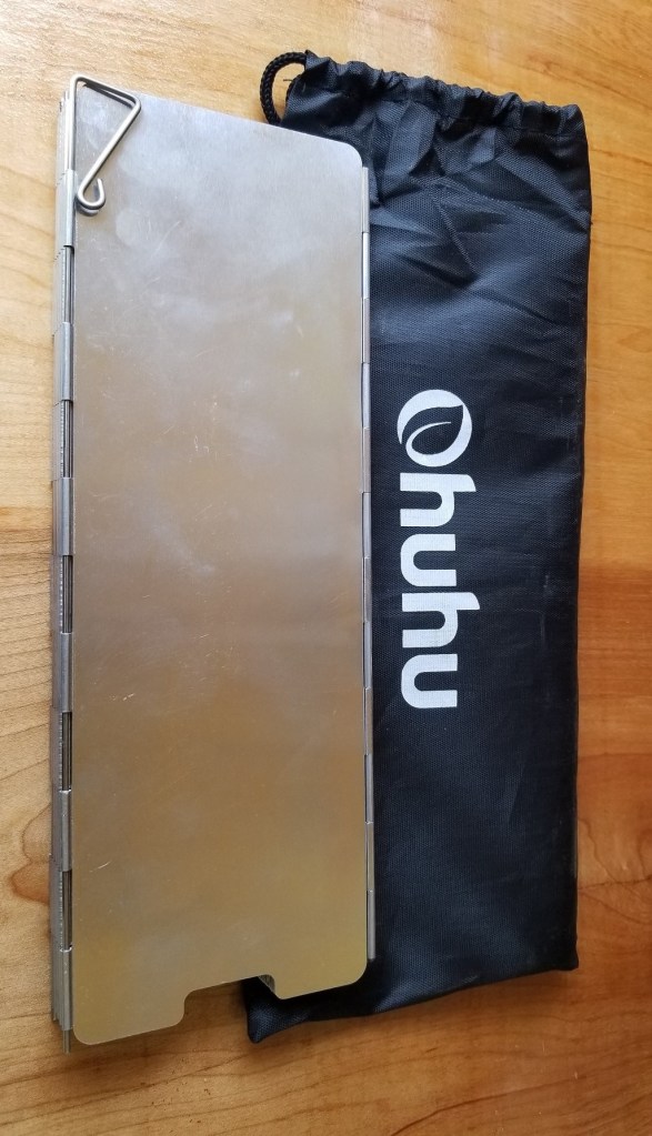camp stove shield, shown folded up with storage pouch