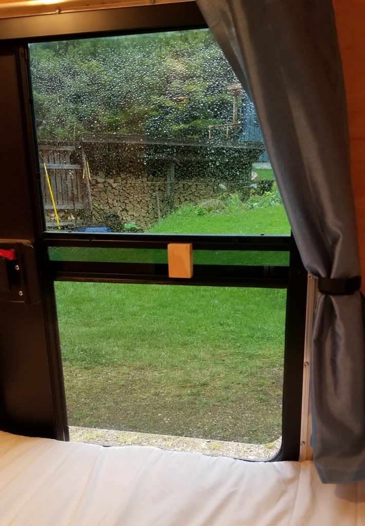 interior of teardrop trailer window, propped open with wood block