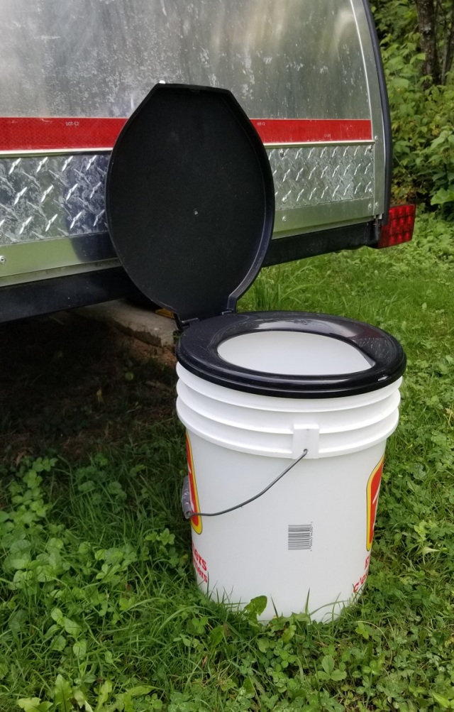 5 gallon pail with a snap-on toilet seat on top