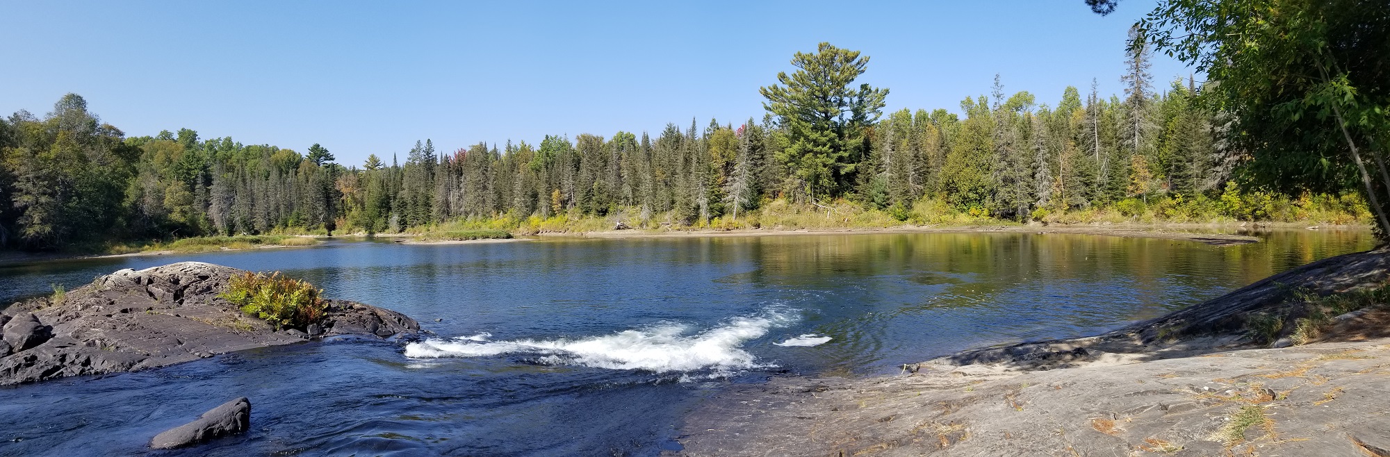 small water cascade with rocky shore