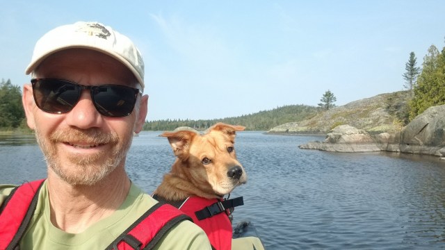 selfie of man and dog kayaking
