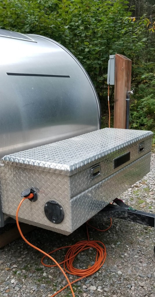 teardrop trailer hooked up to hydro at camp site